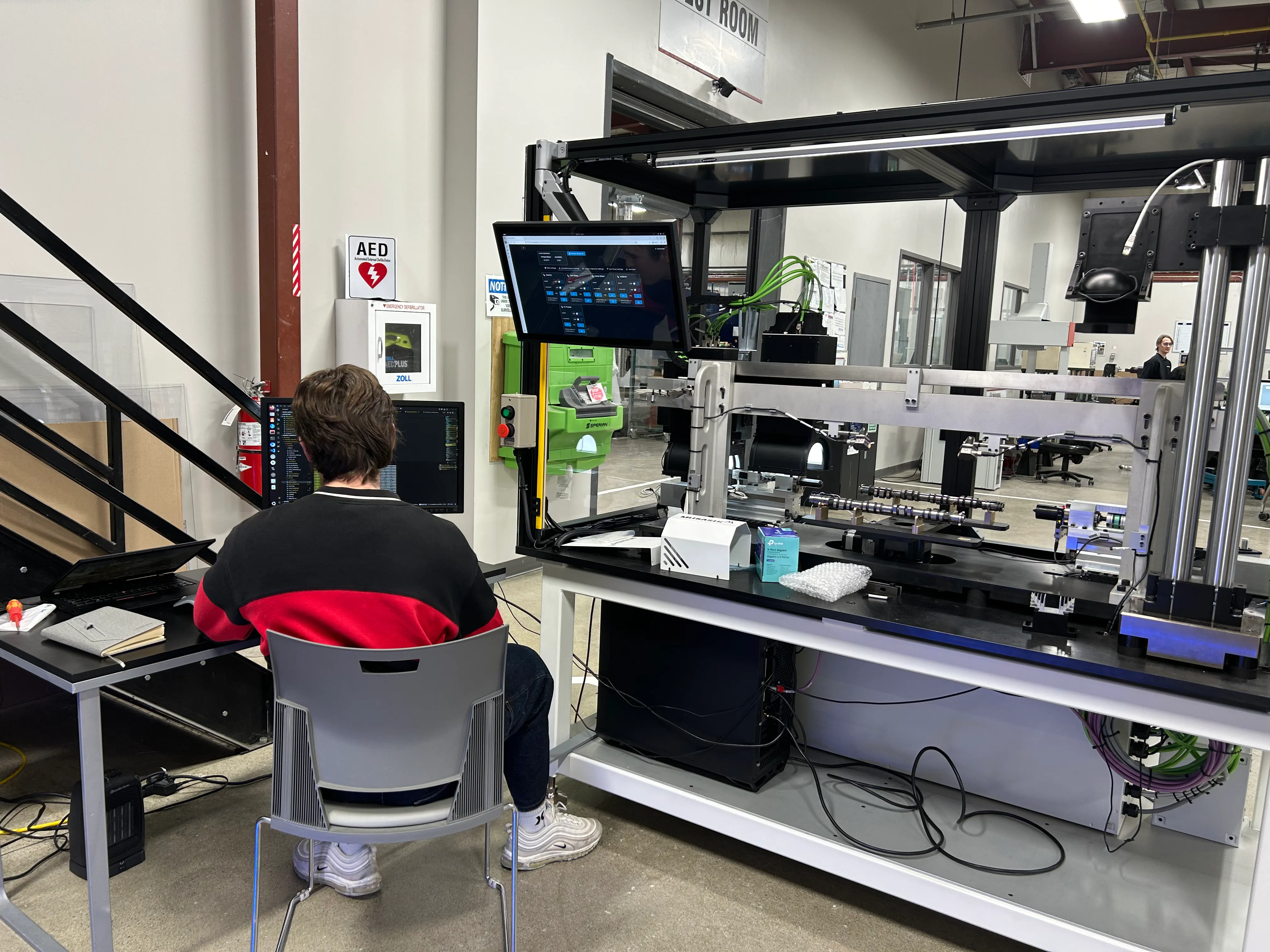 Me sitting at the generation 2 machine for automated camshaft inspection